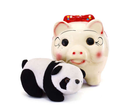 Piggy bank and panda bear isolated on a white backgroundの写真素材