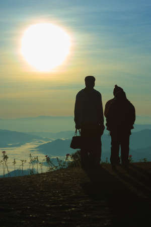 The sun, the fog, the mountains and the love of the family.の写真素材