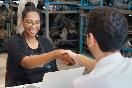 Woman happy and shakehand with man after deal succeed. Diversity of two people, caucasian business...