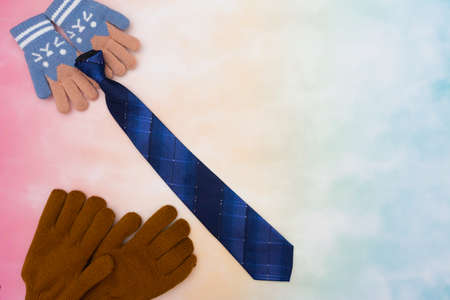 Represent scene of daughter hold and give tie gift to dad by unbranded gloves at left side with colorful background. Background family scene of child gives happy gift to father in father's day conceptの写真素材