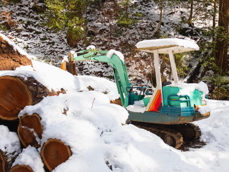 digger or loader work on snow at mountain in winter, excavator stop excavate snow on floor on mountain in asia japan for touristの写真素材