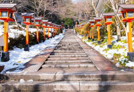 stone stair surrounding with vintage lamp and lamppost on path of temple in winter, stone stair and old retro lantern in temple at asia japan for outdoor light and walking wayの写真素材