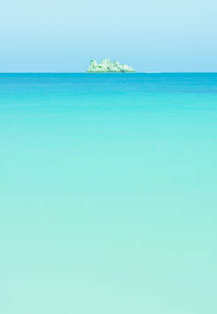 seascape with alone tropic island in deep blue sea, rock island paradise with small beach in summer...