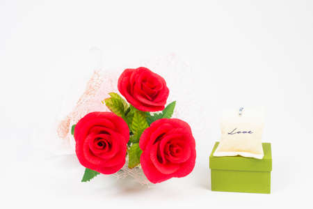 three red rose flower in bunch with love bag on green gift box on white background, beautiful elegance red roses flower of love inspiration in anniversaryの写真素材