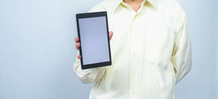 man hold tablet with white screen and left  white copy space backgroundの写真素材