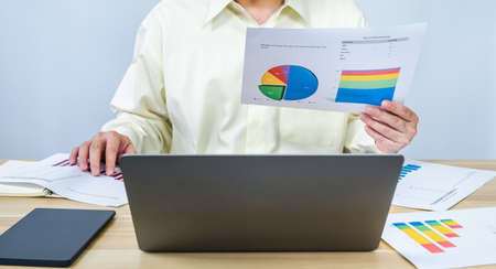man work business graph data on laptop and document, professional businessman busy work on the business data graphの写真素材