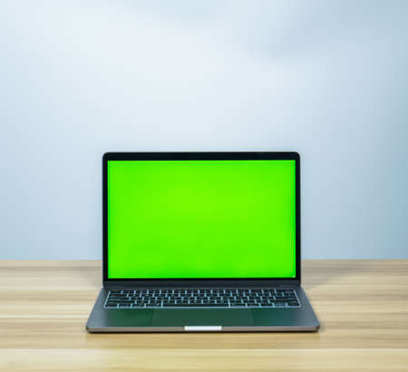 green screen on laptop with white copy space background for making business presentationの写真素材