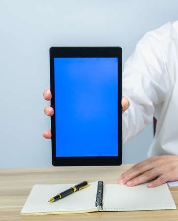 close up vertical of showing blue screen on tablet for making meeting presentation, professional...