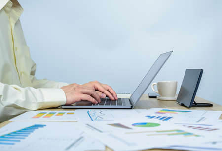 man working on laptop in front of tablet with copy space, professional businessman busy work on the...