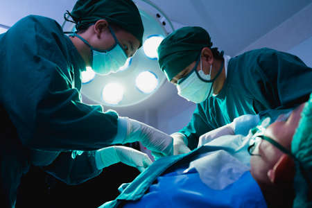 doctor team operate surgery patient under lighting in operating room, operation or surgery room in hospital for doctor and patientの写真素材