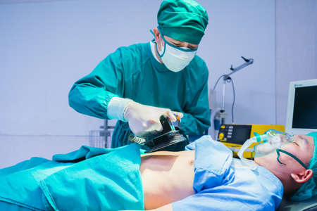 doctor cpr to emergency patient in operating room, operation or surgery room in hospital for doctor and patientの写真素材