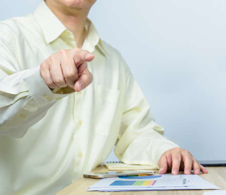 close up man pointing while working on document data graph on working desk, professional businessman busy work on the business data graphの写真素材