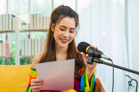 young lgbt women happy singing with music note in living room at home, lifestyle of couple lgbt loving women happy in romance love and funの写真素材