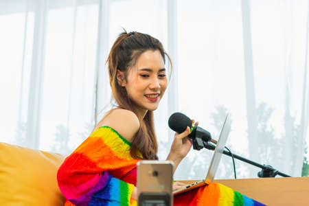 young lgbt women live social online while singing in living room at home, lifestyle of couple lgbt...