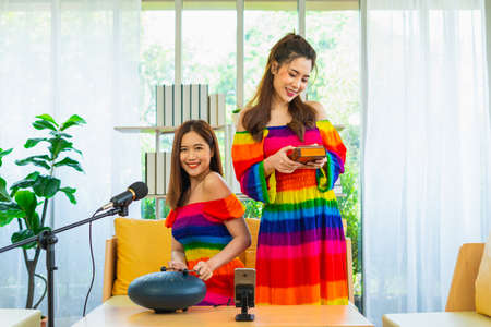 couple lgbt women happy and fun to live playing musical instrument in living room at home, lifestyle of couple lgbt loving women happy in romance love and funの写真素材