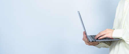 worker using laptop and turn left white copy space background for meeting presentation, professional businessman busy work on the businessの写真素材
