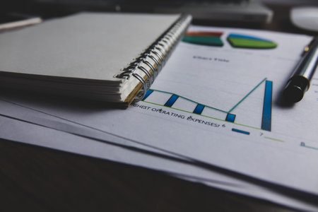 Close-up of a notepad with a graph on the table