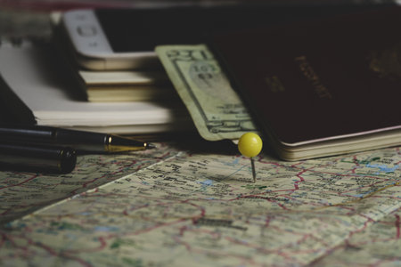 travel concept. passport, compass, money and notebook on the mapの写真素材