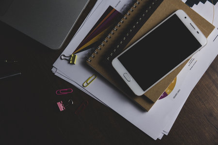 Office desk table with laptop, smartphone, supplies and coffee cup.の写真素材