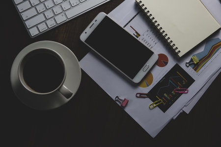 Top view of working table with computer and coffee cup, stock photo
