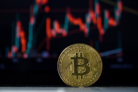 Golden bitcoin on the background of the candlestick chart. Cryptocurrency concept.の写真素材