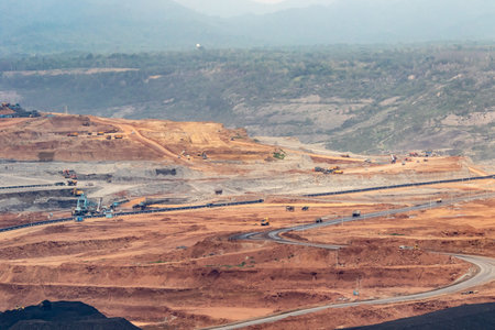 Coal mining in an open pit with lots of machinery and equipmentの写真素材