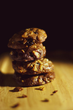 Homemade sweet chocolate cookies on wooden table with black backgroundの写真素材