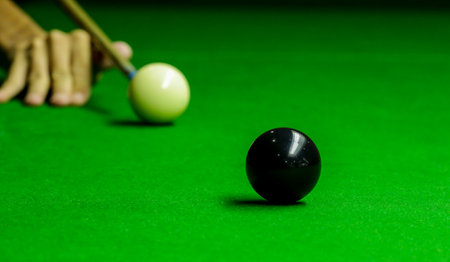 Man playing snooker balls on green snooker tableの写真素材