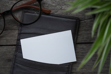 Name card mockup with card holder on old wooden table backgroundの写真素材