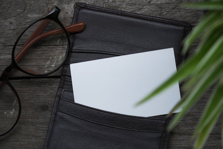 Name card mock up with card holder on old wooden table backgroundの写真素材
