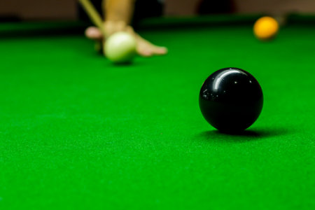 Man playing snooker balls on green snooker tableの写真素材