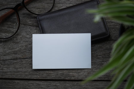 Business card mock up with card holder on old wooden table backgroundの写真素材