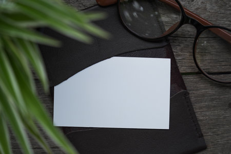 Business card mock up with card holder on old wooden table backgroundの写真素材