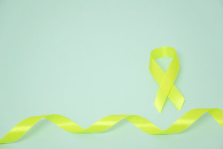 Yellow ribbon Sarcoma Awareness concept on blue backgroundの写真素材