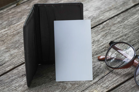Business card mock up with card holder on old wooden table backgroundの写真素材