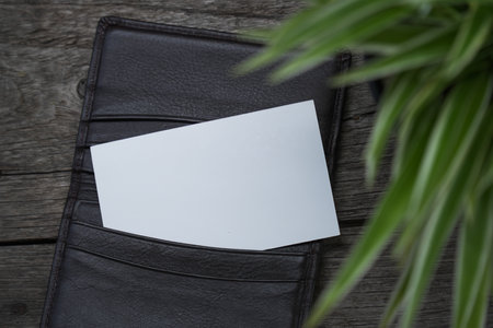 Business card mock up with card holder on old wooden table backgroundの写真素材
