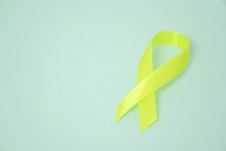 Yellow ribbon Sarcoma Awareness concept on blue backgroundの写真素材