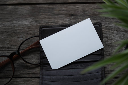 Business card mock up with card holder on old wooden table backgroundの写真素材