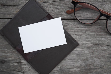 Business card mock up with card holder on old wooden table backgroundの写真素材