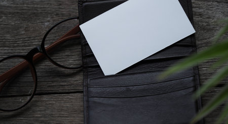 Business card mock up with card holder on old wooden table backgroundの写真素材