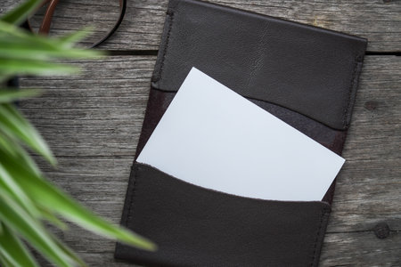 Business card mock up with card holder on old wooden table backgroundの写真素材
