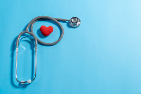 Stethoscope and red heart on blue background. Health care conceptの写真素材