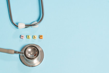 Stethoscope and cubes with word BUDGET on blue backgroundの写真素材