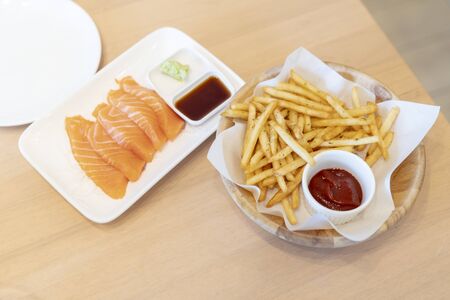 Salmon Slides with Wasabi and French Fries in a Japanese Restaurant