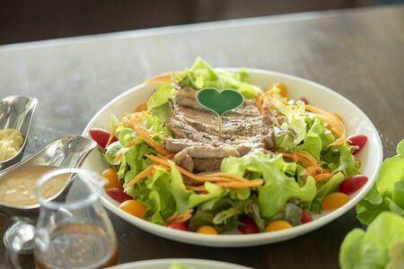 Pork steak in a restaurant with beautiful dishesの写真素材