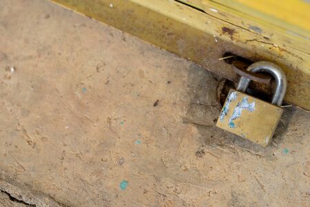 The steel door is locked with a tight lock to prevent robbers and outsiders.の写真素材