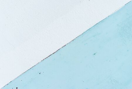 The background of the pastel-blue plaster is striking, beautiful and simple.の写真素材
