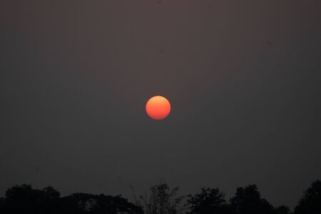 The sun is about to set, the red sun is like an egg yolk.の写真素材