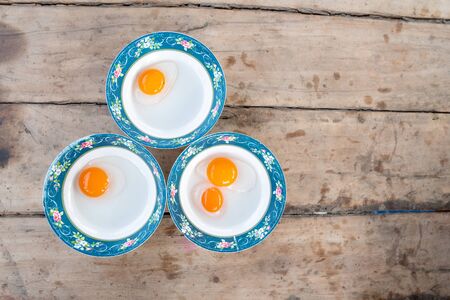Duck egg yolks in comparison to egg completion.の写真素材