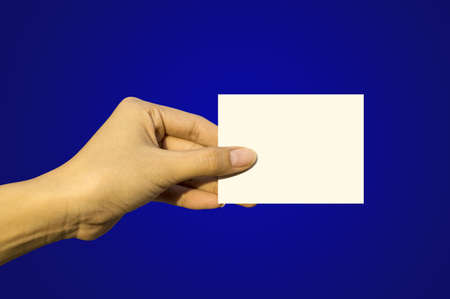 Hand holding blank paper label or tag の写真素材